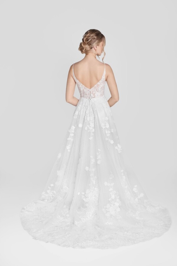 Show stopping wedding dress with floral lace details and spaghetti straps and buttons down the back.