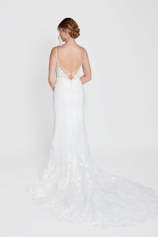 Simple bohemian wedding dress with spaghetti straps and lace overlay train.