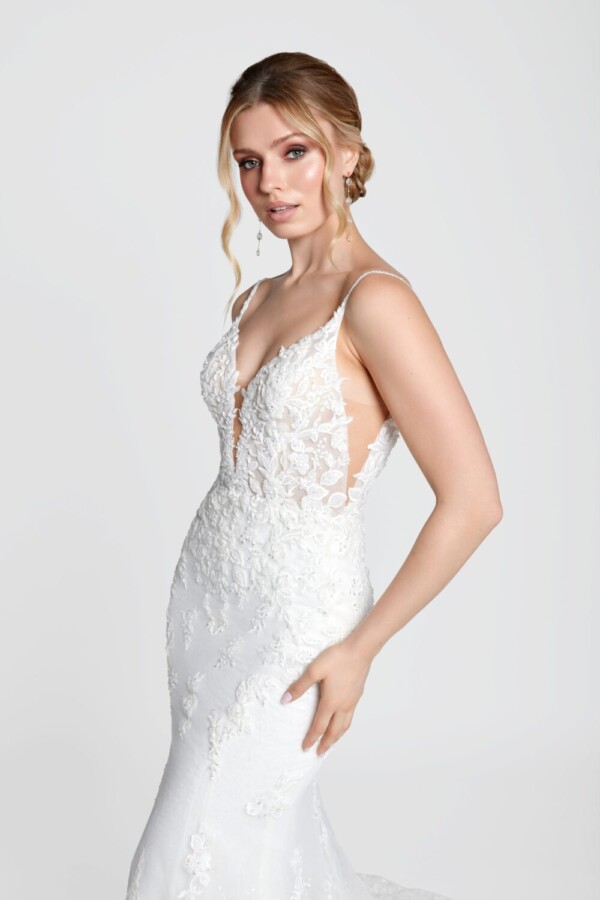 Simple bohemian wedding dress with spaghetti straps and deep v cut bodice with a lace overlay train.