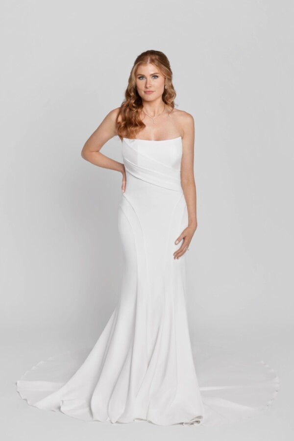 Sleeveless, fit and flare wedding dress with crossover folding on the bodice.