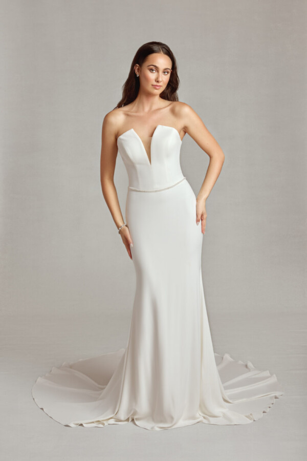 Simple, sleeveless wedding dress with a deep v cut neckline, dropped waist and simple train.