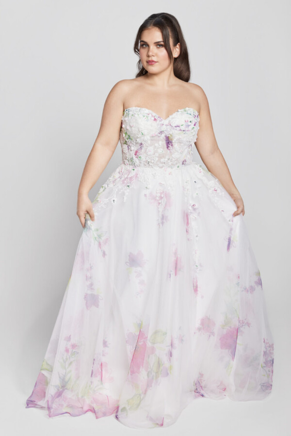 Lovely bride to be wearing one of The Wedding Shoppe's wedding dresses with color. The sweetheart neckline and subtle purple florals are printed throughout.