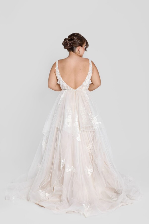 Charming bride to be wearing a square neckline wedding dress with floral lace on the bodice and decals throughout the tulle skirt.