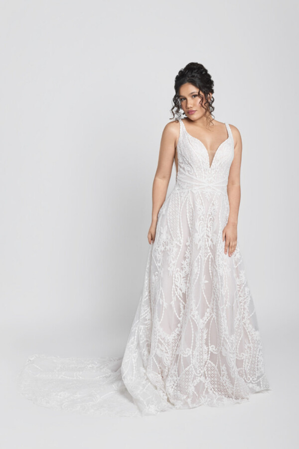 Bride to be wearing an art deco inspired lace wedding dress with chunky lace details and a deep v cut neckline.