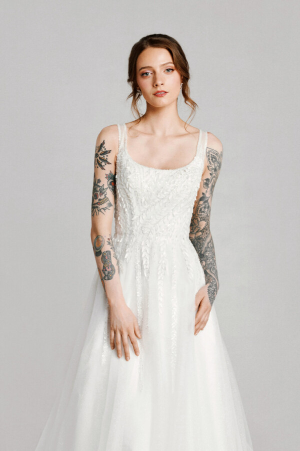 A bride in a white flowy lace floral slim fitted dress.