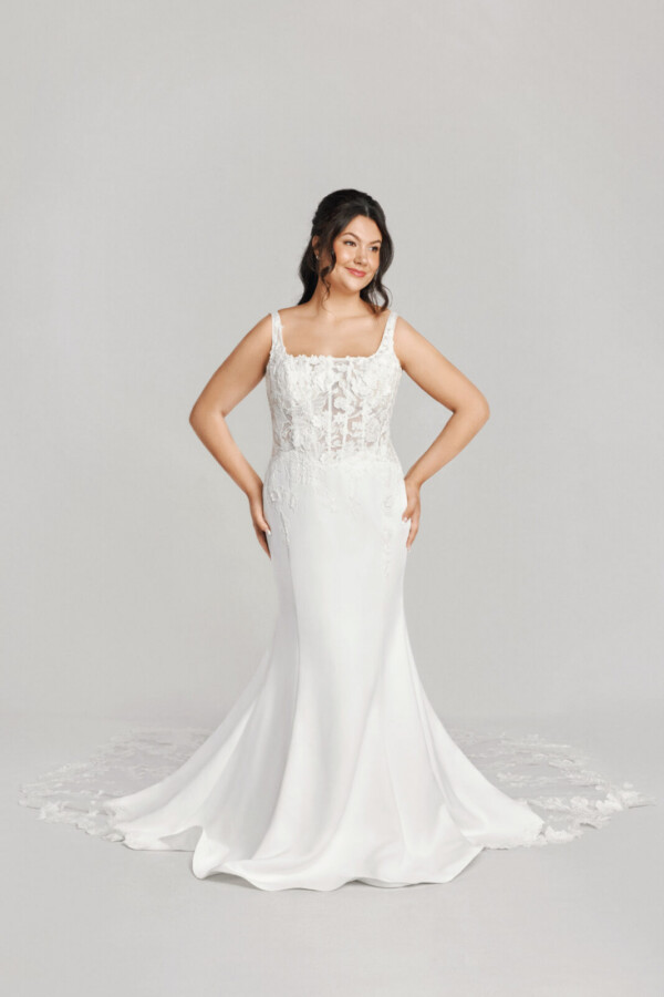 A bride in a white flowy lace floral dress.