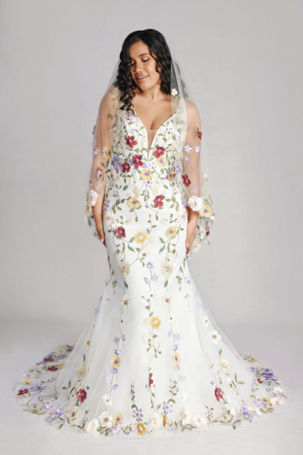 A bride in a sheer floral fitted slim strap dress.