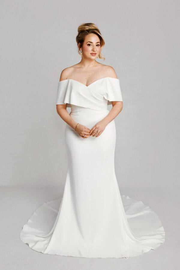 A bride in a white flowy off the shoulder dress.