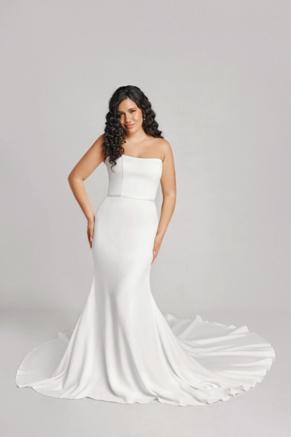 A bride in a white fitted slim strapless dress.