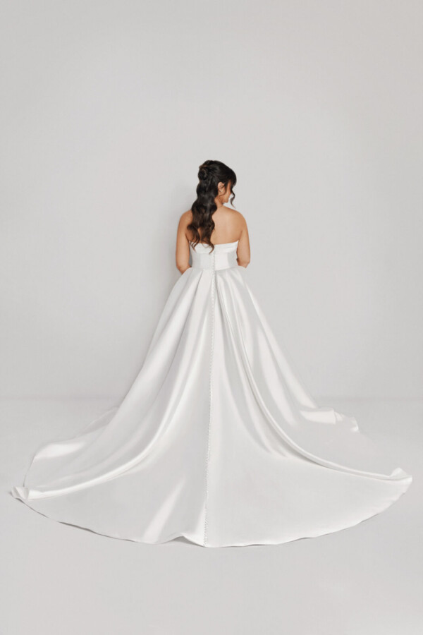 A bride in a white fitted strapless dress.