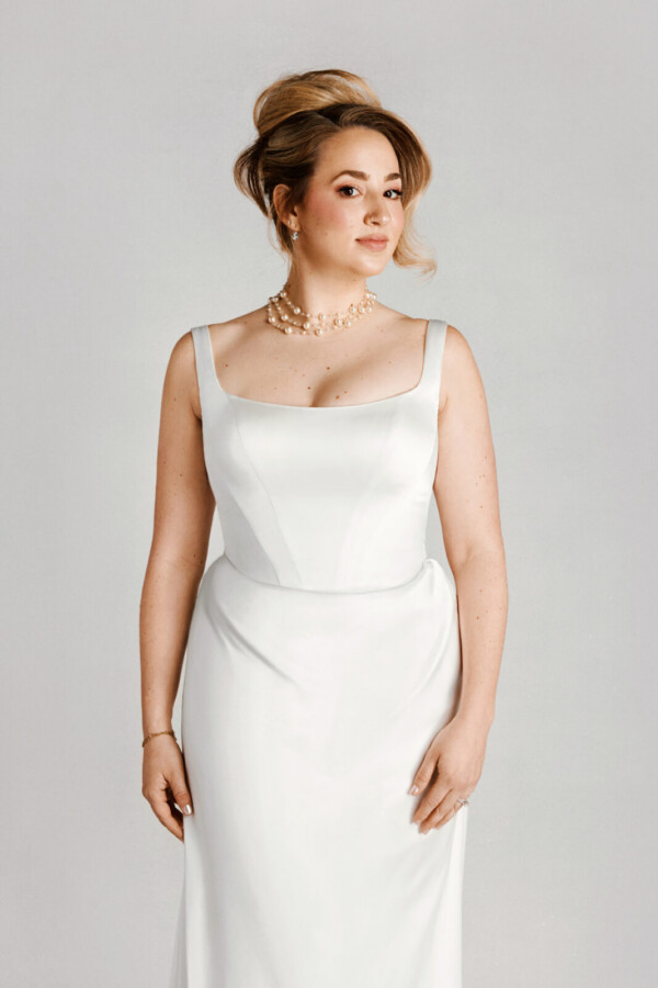 A bride in a white fitted dress.