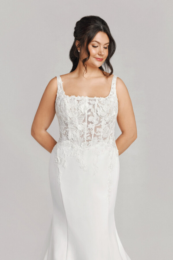 A bride in a white flowy lace floral dress.