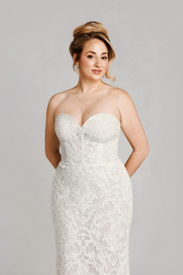 A bride in a white fitted strapless dress.