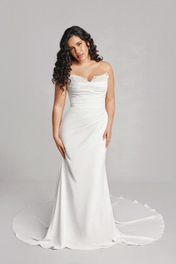 A bride in a white fitted strapless dress.