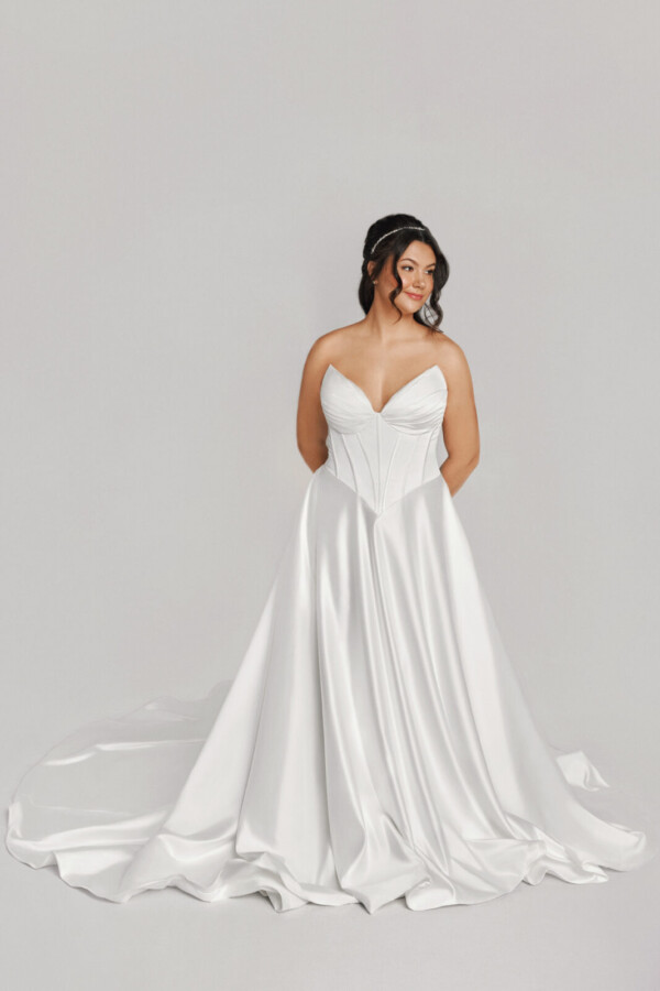 A bride in a white fitted strapless dress.